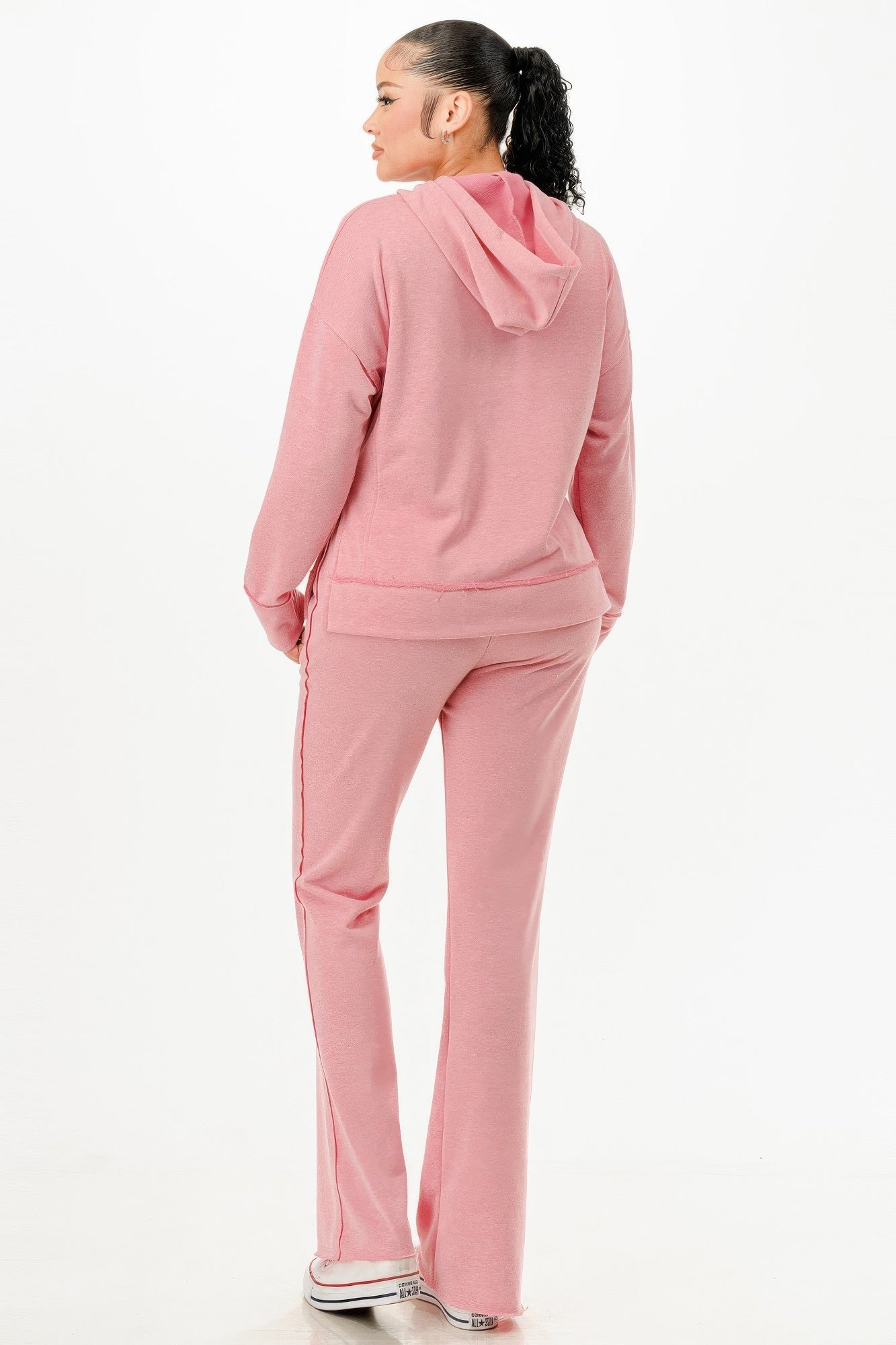 Back view of woman wearing comfortable pink hoodie and pants casual outfit set from VacationGrabs
