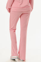 Back view of comfortable pink hoodie and pants set for women by VacationGrabs