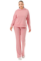 Woman wearing comfortable pink hoodie and pants set from VacationGrabs for casual wear