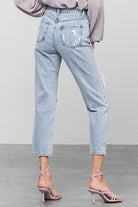 Light blue women's jeans by Denim Lab USA, perfect for travel with a comfortable fit and trendy distressed details