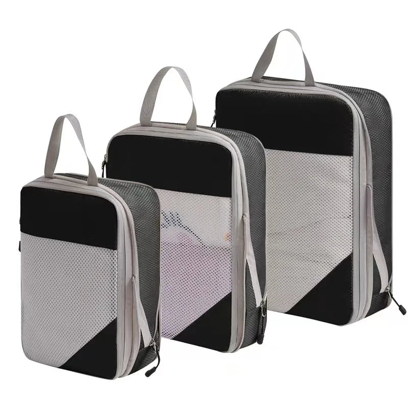 Set of three black compression packing cubes for travel organization