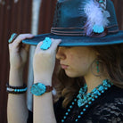 Beautiful copper hoop earrings with turquoise, paired with turquoise accessories and a stylish hat