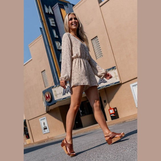 Women's cork sole summer sandals by Makers Shoes worn with a light floral dress outdoors