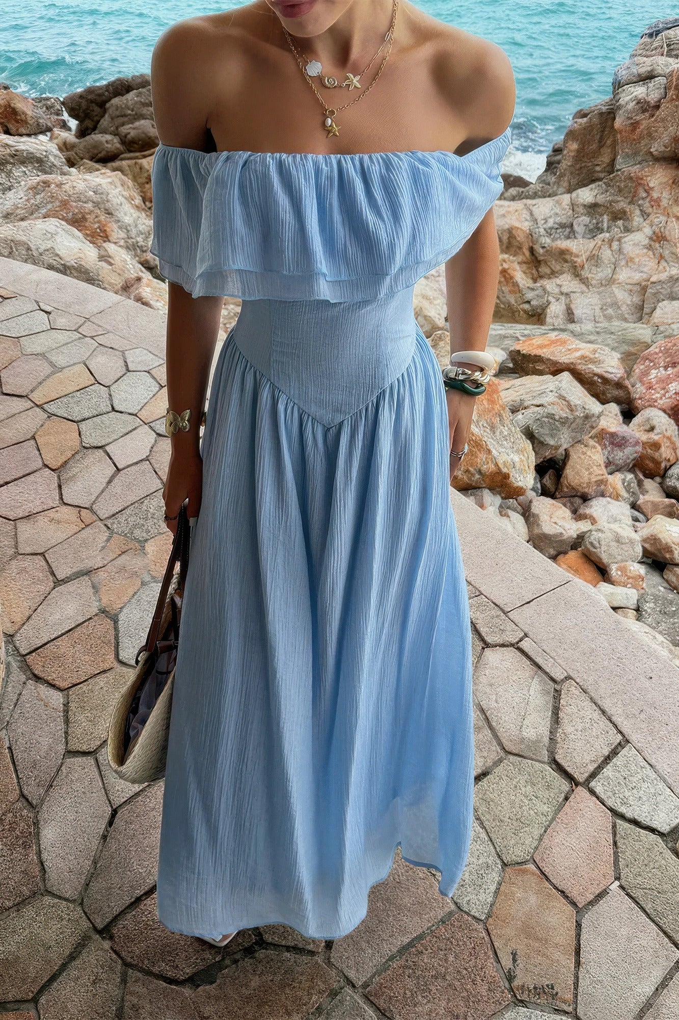 Women's blue corset dress made from lightweight fabric, perfect for beach outings