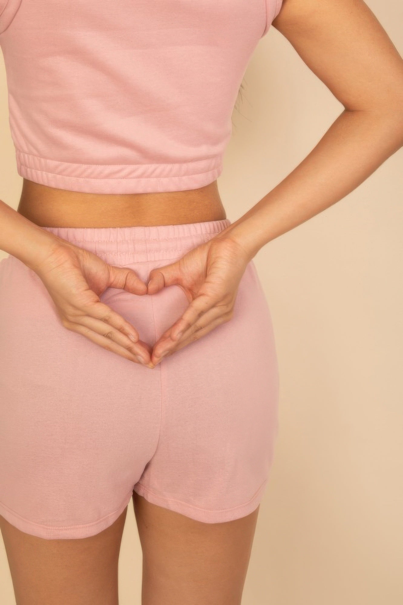 Light pink cotton French terry crop top and shorts set with a heart shape hand gesture