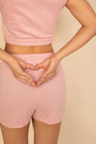 Light pink cotton French terry crop top and shorts set with a heart shape hand gesture