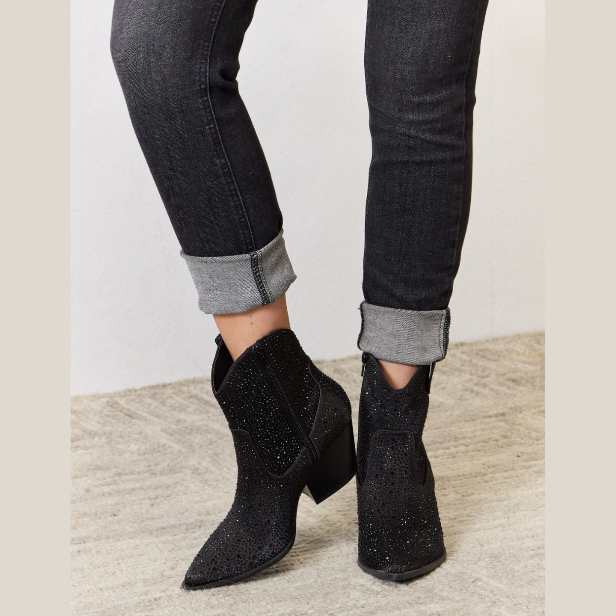 Women's black cowboy boots with sparkling embellishments for stylish wear