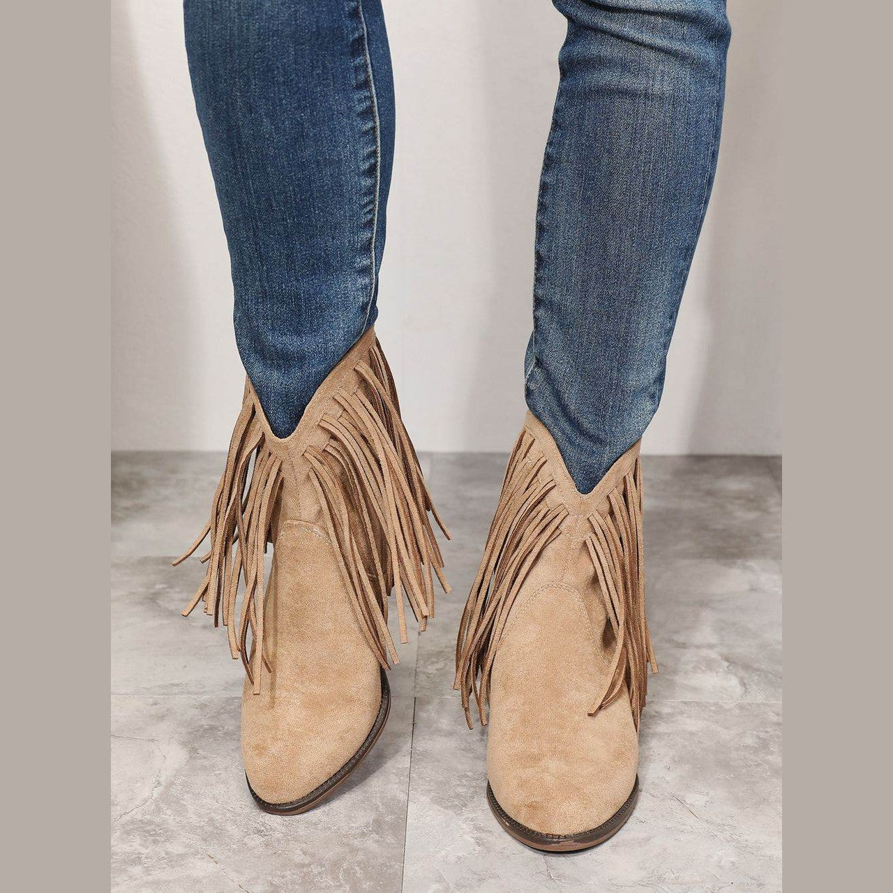 Women's tan suede cowboy boots with fringe details for stylish outfits