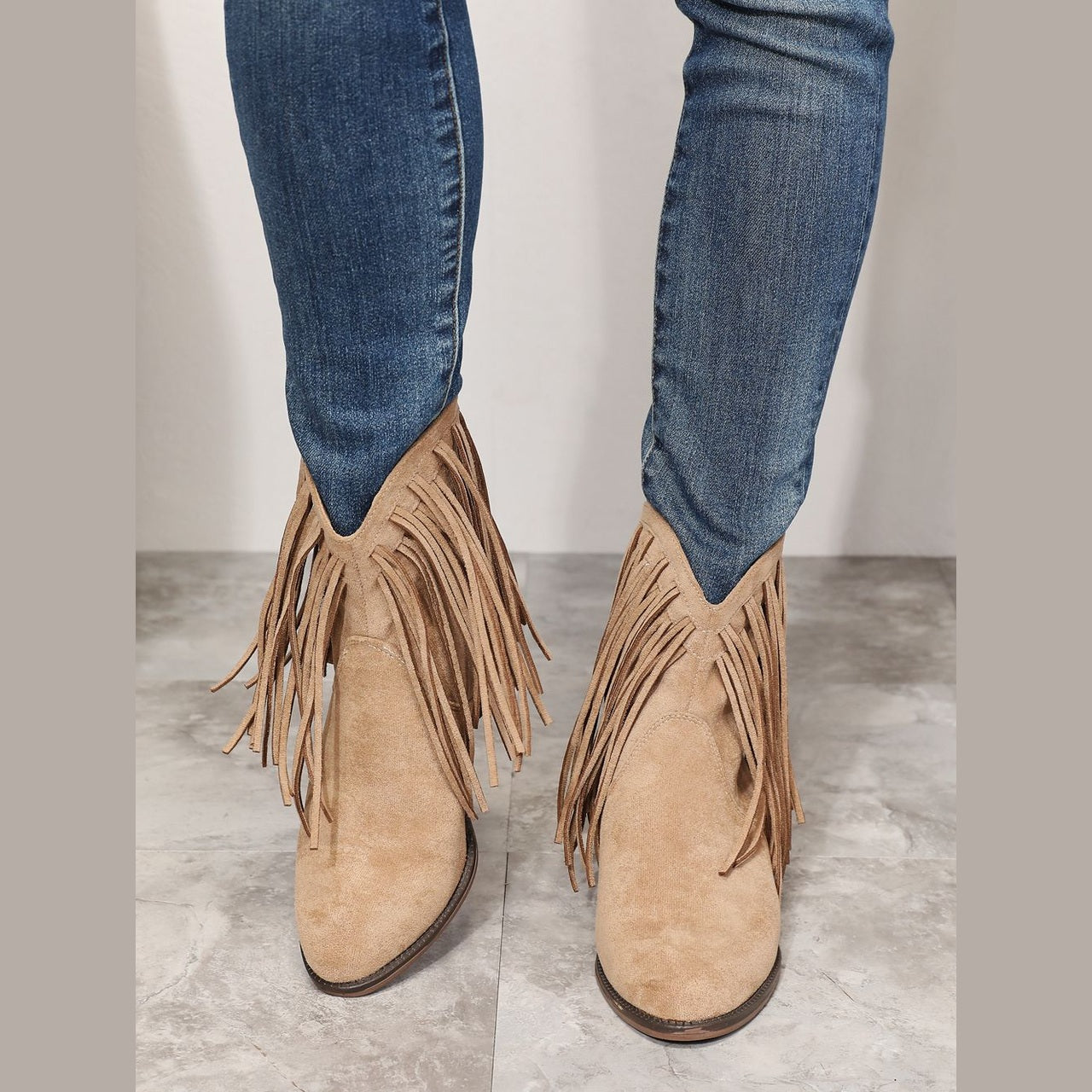 Women's beige cowboy boots with fringe detail for stylish outfits