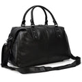 Sleek black cowskin leather travel bag with sturdy handles and a detachable shoulder strap