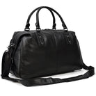 Sleek black cowskin leather travel bag with sturdy handles and a detachable shoulder strap
