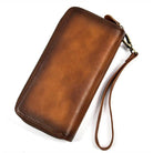 Brown crazy horse leather wallet with a wrist strap and zip closure for secure storage
