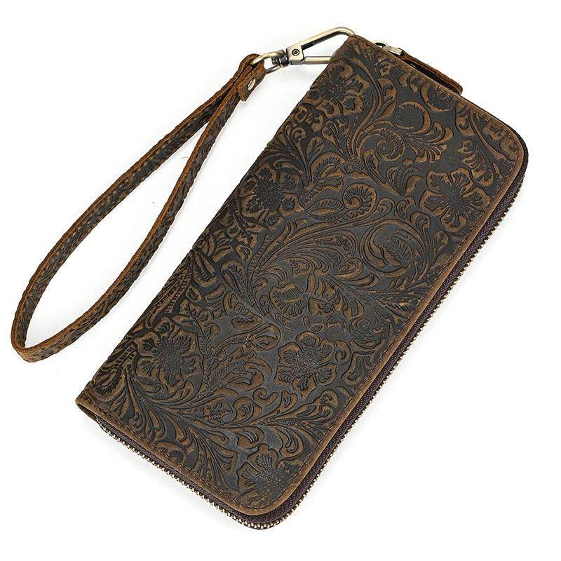 Stylish crazy horse leather wallet with intricate floral embossing and wrist strap for convenience