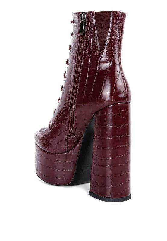 Burgundy crocodile pattern platform boots with a chunky heel and side zipper detail