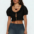 Women's black cotton crop top with scalloped neckline, perfect for summer outings