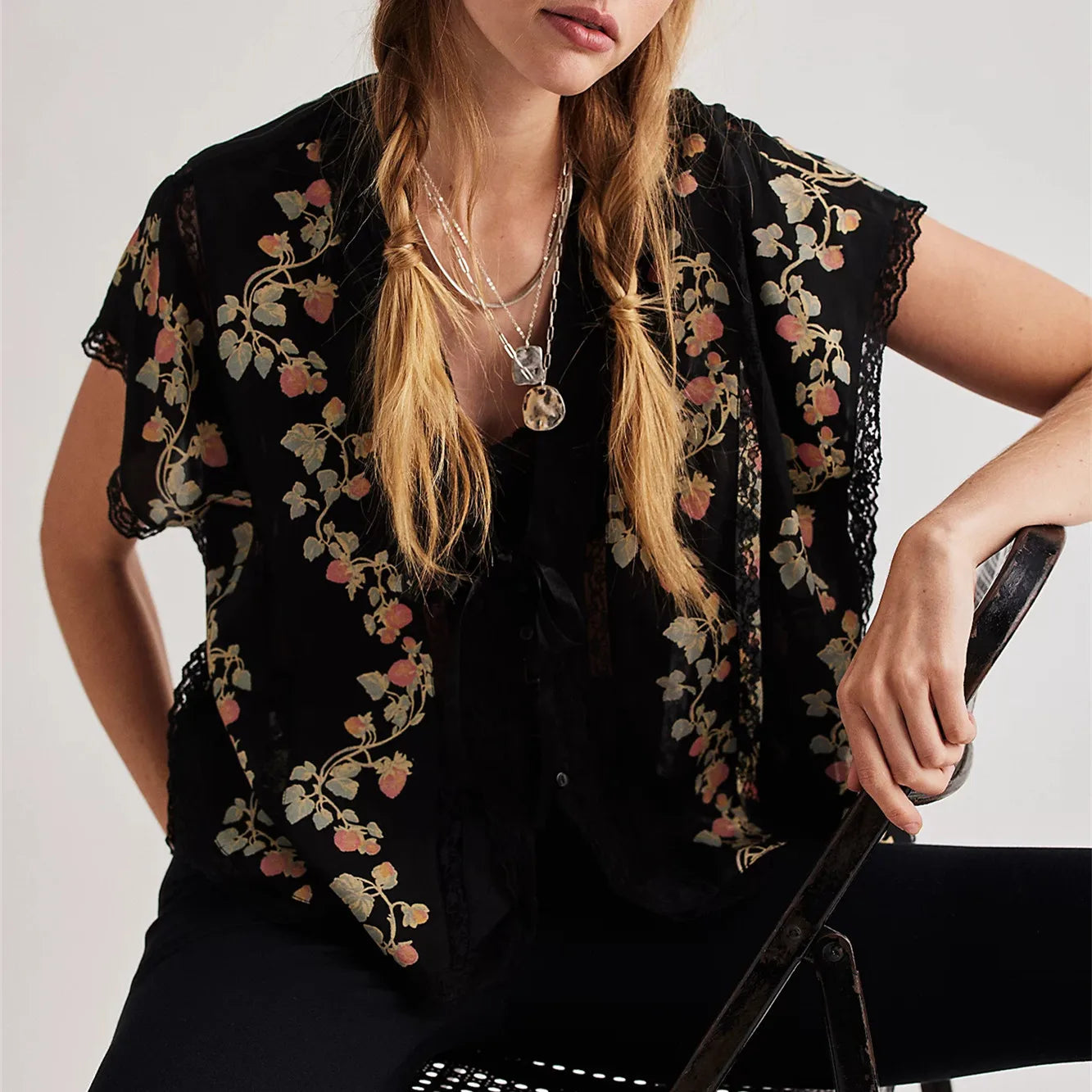 Women's black crop top with floral print, perfect for casual outings