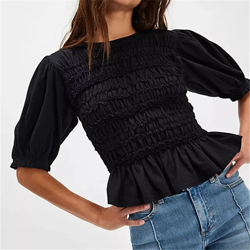 Women's black crop top with smocked detail, perfect for casual outings