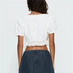 Women's white crop top with scalloped hem, perfect for summer outings