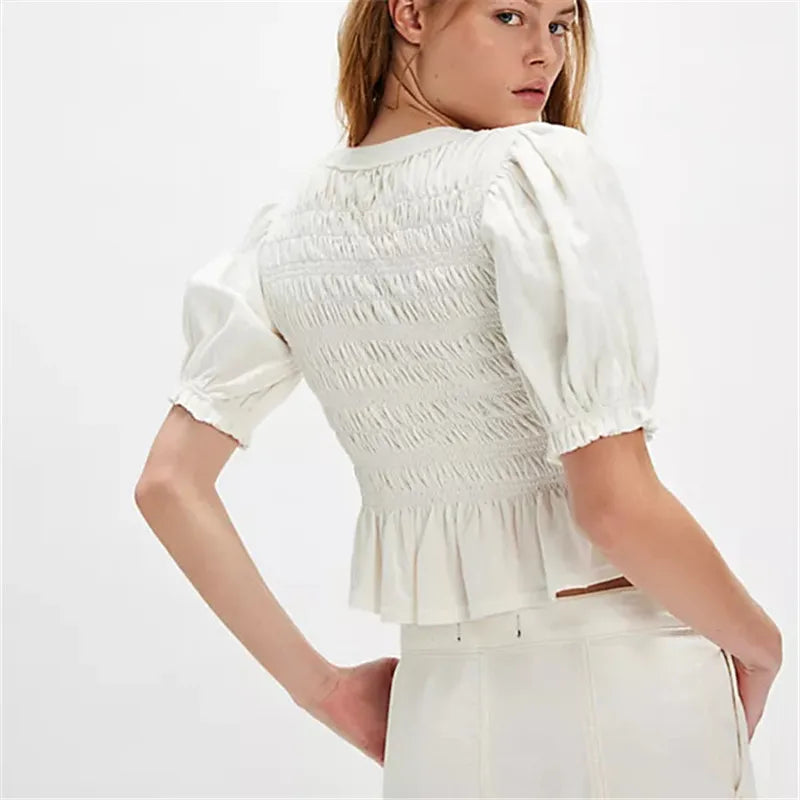 Women's white crop top with puff sleeves and smocked back design