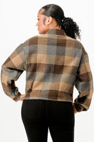 Back view of a stylish cropped brown flannel jacket with a plaid pattern for women
