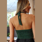 Back view of a green cropped fuzzy halter top with adjustable ties from Leto Accessories