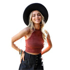 Leto Accessories cropped fuzzy halter top in rust color, styled with a wide-brim hat and casual jeans