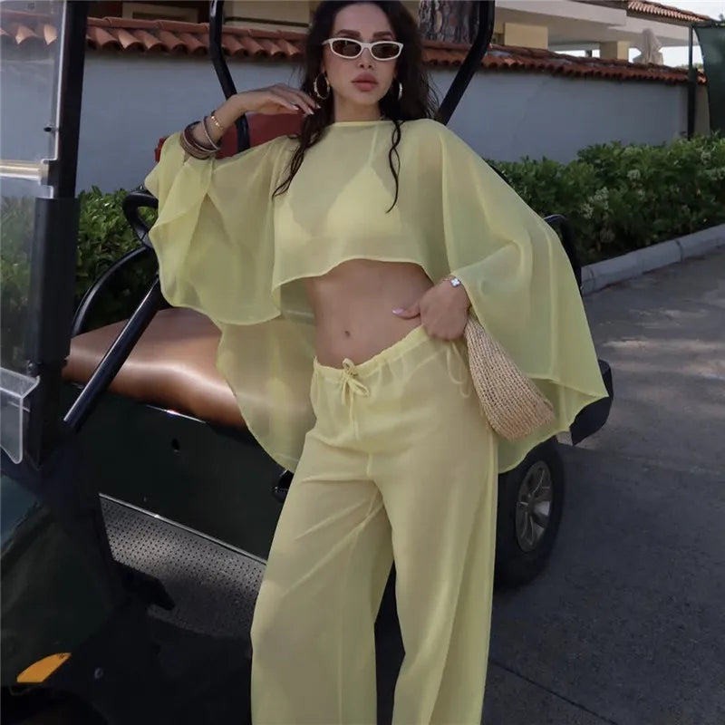 Women's yellow cropped top and matching pants, perfect for beach outings