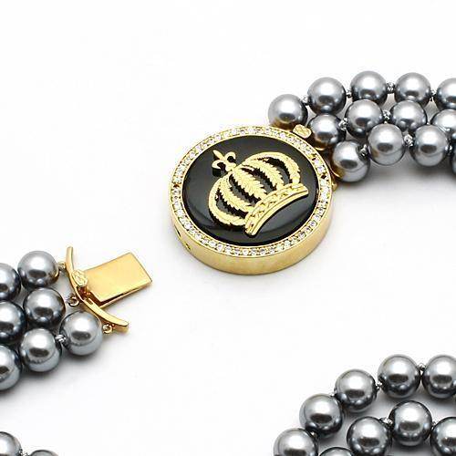 VacationGrabs crown pendant statement jewelry with black and gold design on a pearl necklace