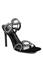 Women's black cut out stiletto heel sandals with decorative circular accents