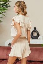 Cute summer ruffle romper in light beige with ruffled shoulders and pockets for a stylish look