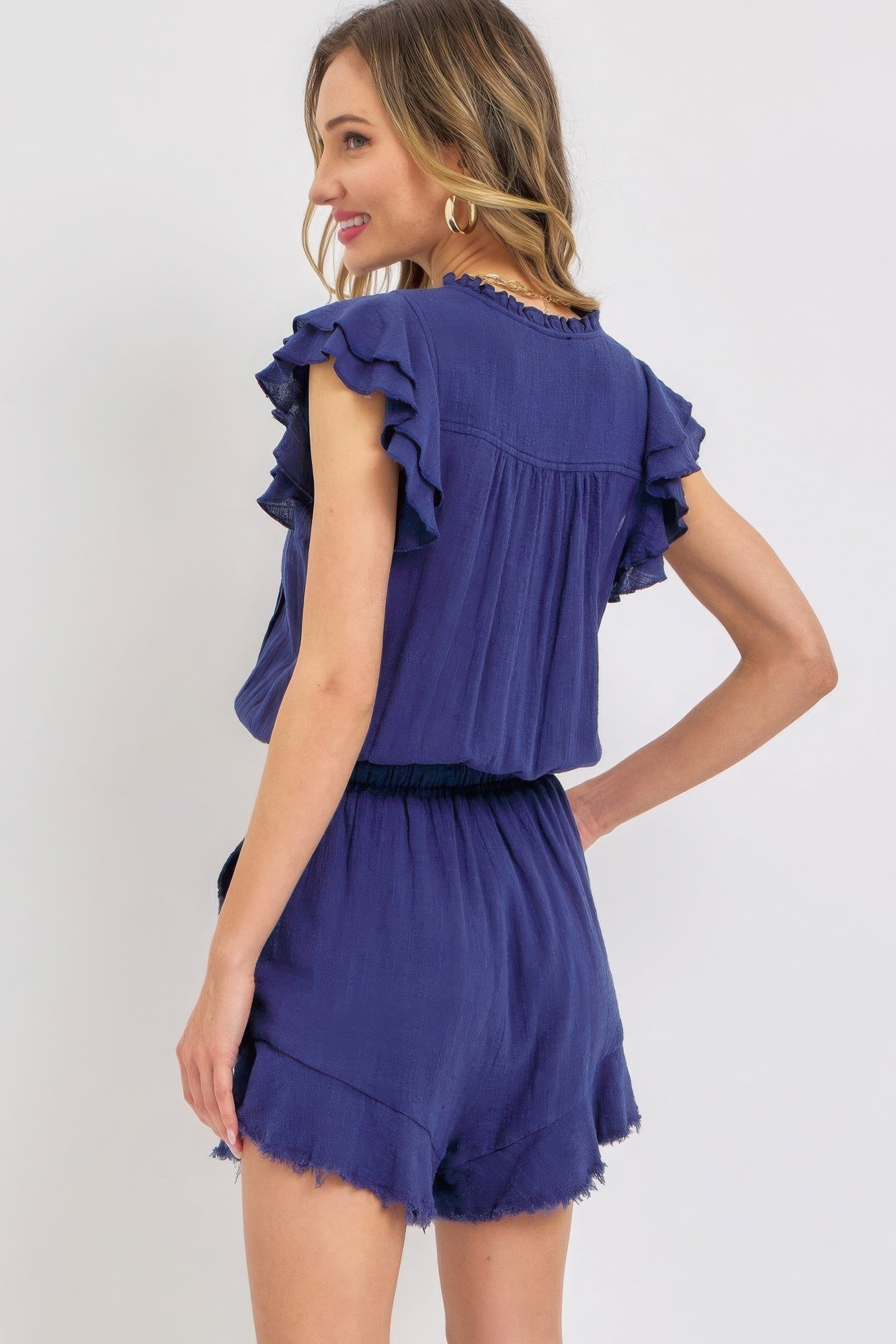 Cute summer ruffle romper in navy with flounce sleeves and a relaxed fit from VacationGrabs