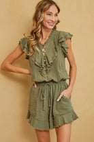 Cute summer ruffle romper in olive green with button details and pockets for stylish outings