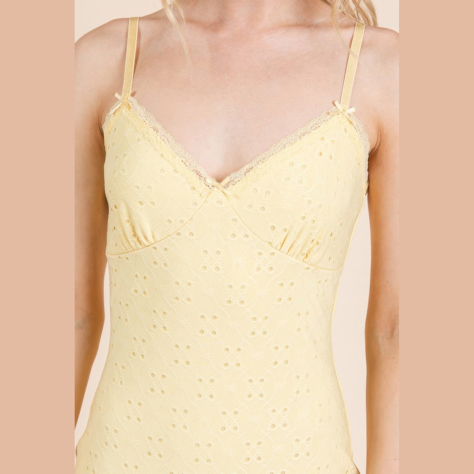 Light yellow cute vacation mini dress with delicate lace trim and adjustable straps for summer outings