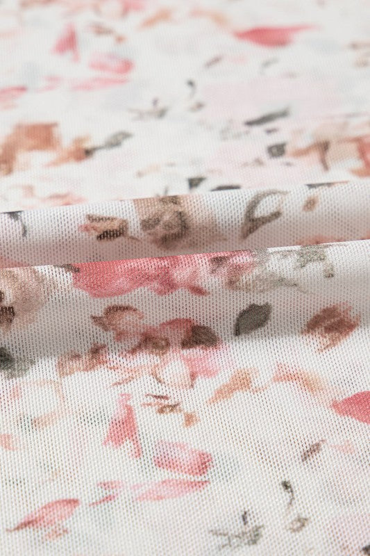 Close-up of fabric featuring a mock neck floral blouse for women in soft pastel colors