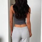 Woman wearing a gray daily wear soft bandeau shirt paired with light gray pants from VacationGrabs