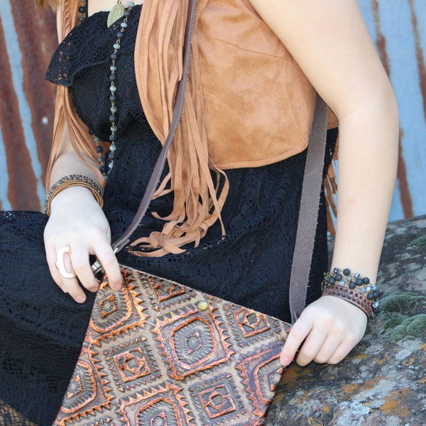 Stylish model wearing a dark brown vintage leather cuff with a black lace dress and stylish accessories