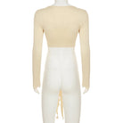 Back view of womens cropped tie front top in beige with long sleeves and open tie detail