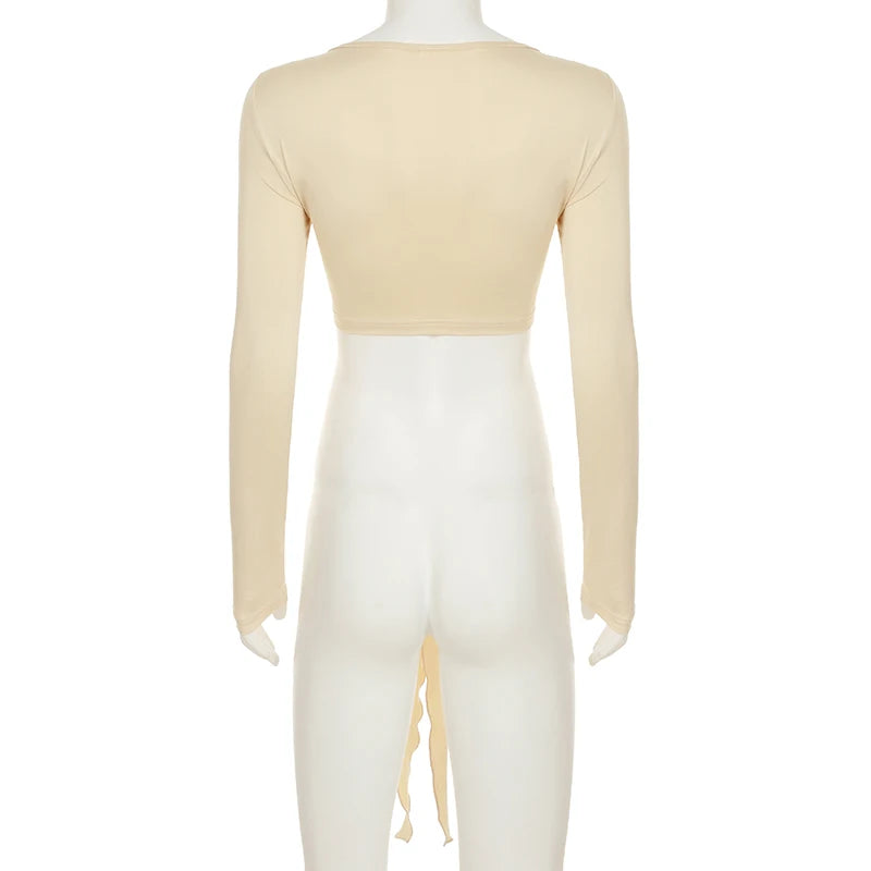 Back view of womens cropped tie front top in beige with long sleeves and open tie detail