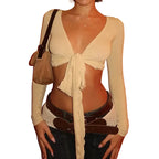 Womens cropped tie front top in beige with long sleeves styled with belt and bag