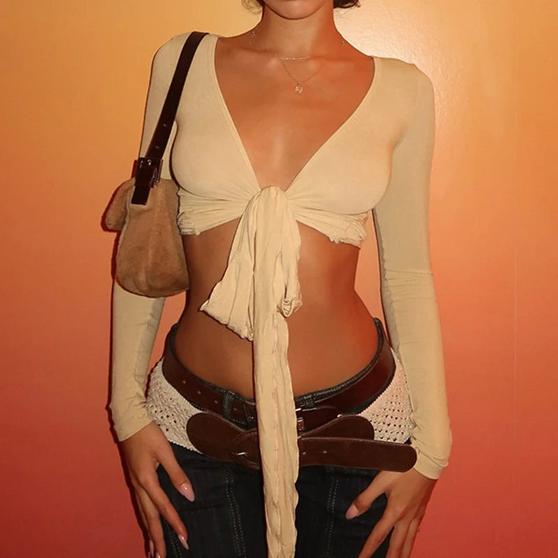 Womens cropped tie front top in beige with long sleeves styled with belt and bag