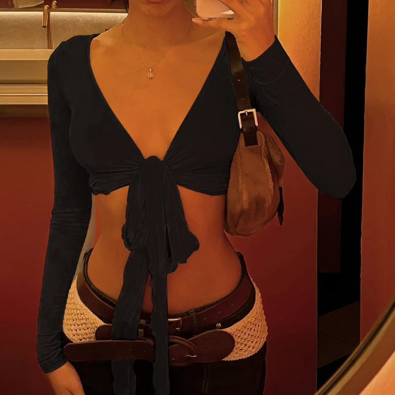 Womens cropped tie front top in black with long sleeves styled with brown belt and handbag