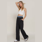 Women's denim accent wide leg pants by VacationGrabs styled with a white crop top and casual sneakers