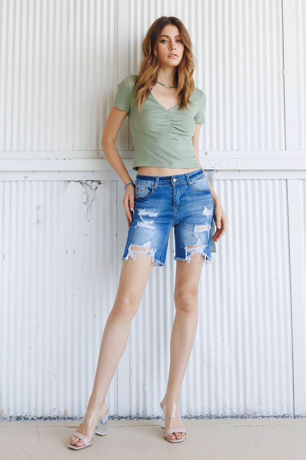 Women's distressed denim shorts in blue for casual summer outings