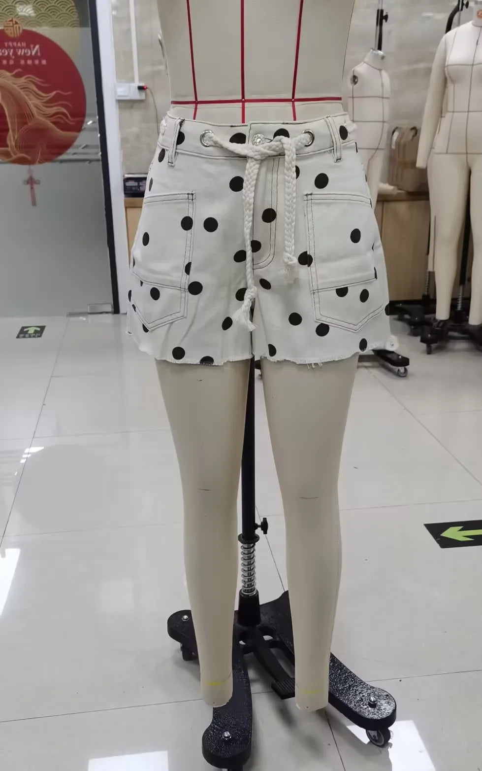 Women's white polka dot shorts in denim for casual summer outings