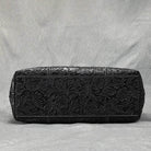 Stylish black designer shoulder bag for laptops with intricate floral detailing and spacious interior
