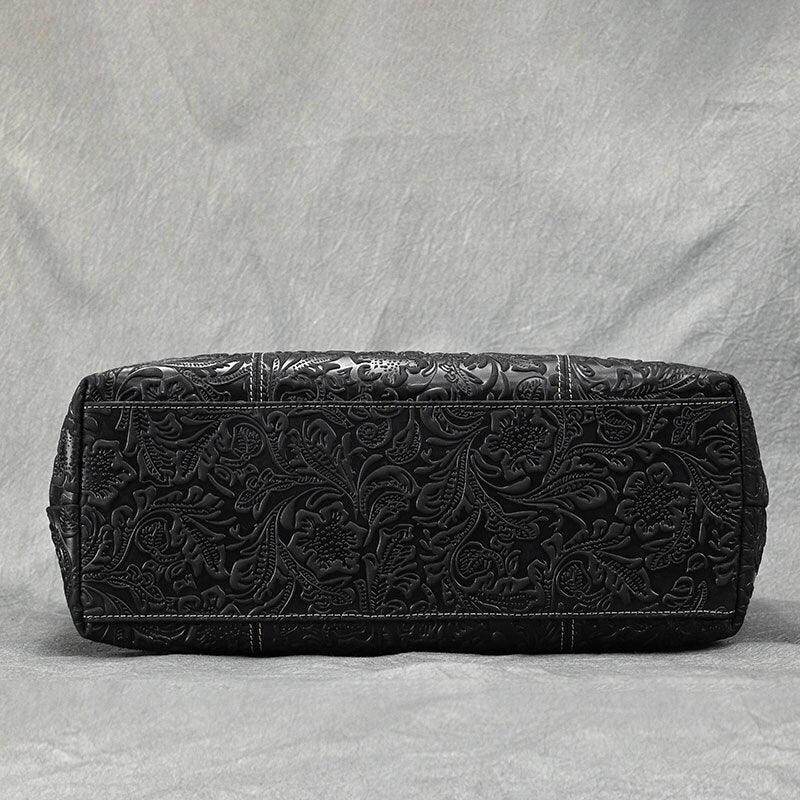 Stylish black designer shoulder bag for laptops with intricate floral detailing and spacious interior