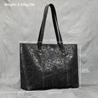 Stylish black designer shoulder bag for laptops with embossed floral pattern and sturdy straps