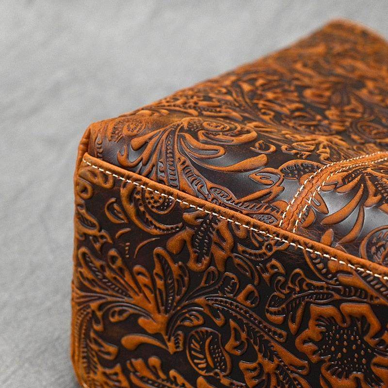 Intricately embossed brown designer shoulder bag for laptops with floral patterns and durable stitching