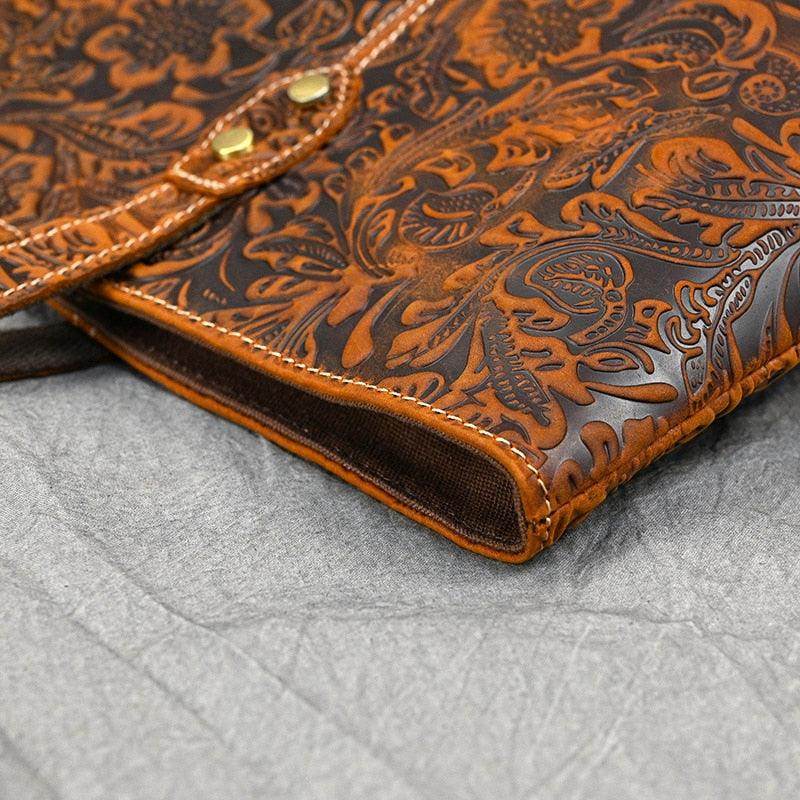 Stylish brown designer shoulder bag for laptops with intricate floral pattern and quality stitching