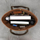 Interior of a stylish designer shoulder bag for laptops showcasing organized compartments and accessories